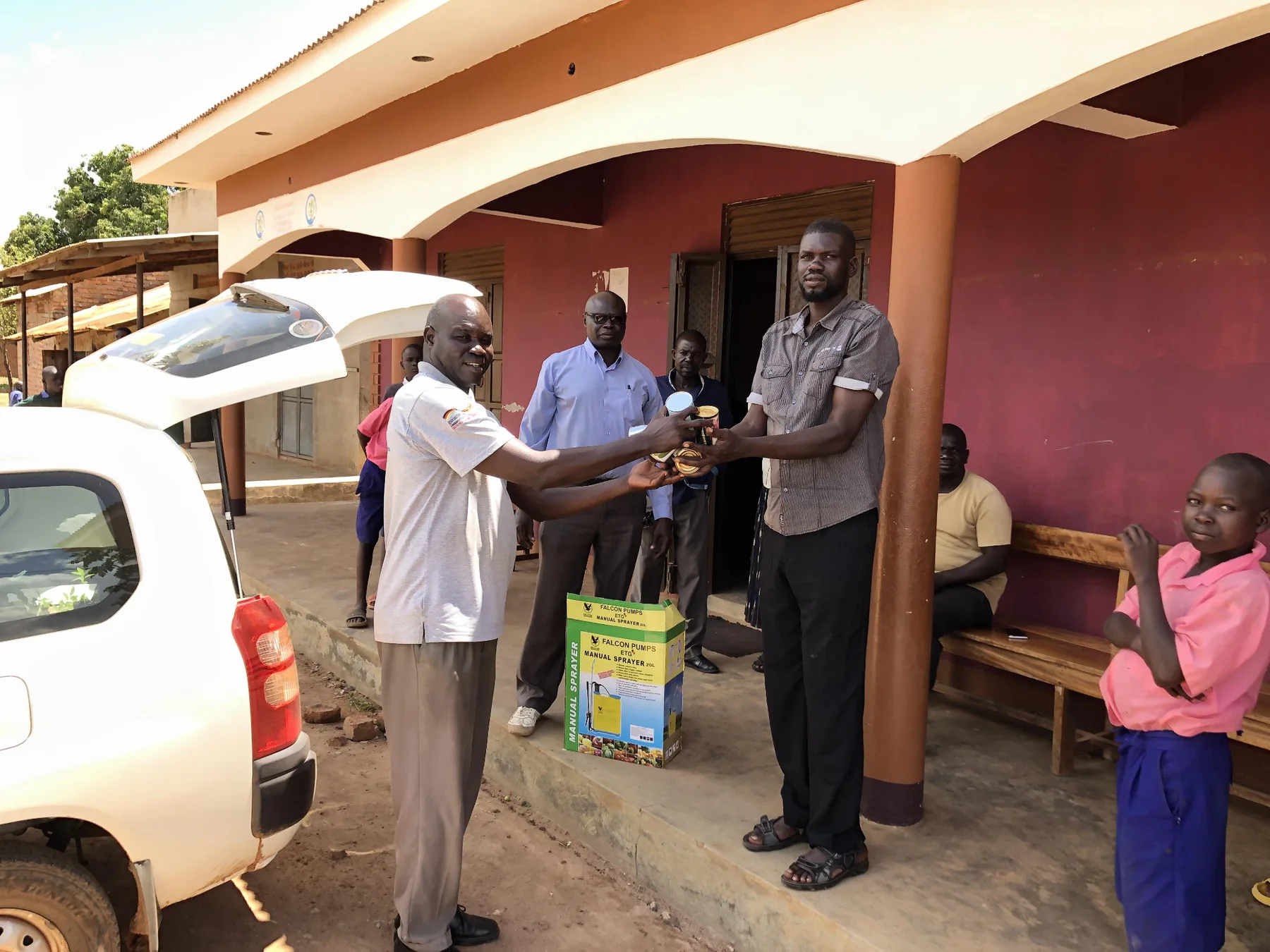 Community members receive agricultural equipment through a YWAFT farming initiative