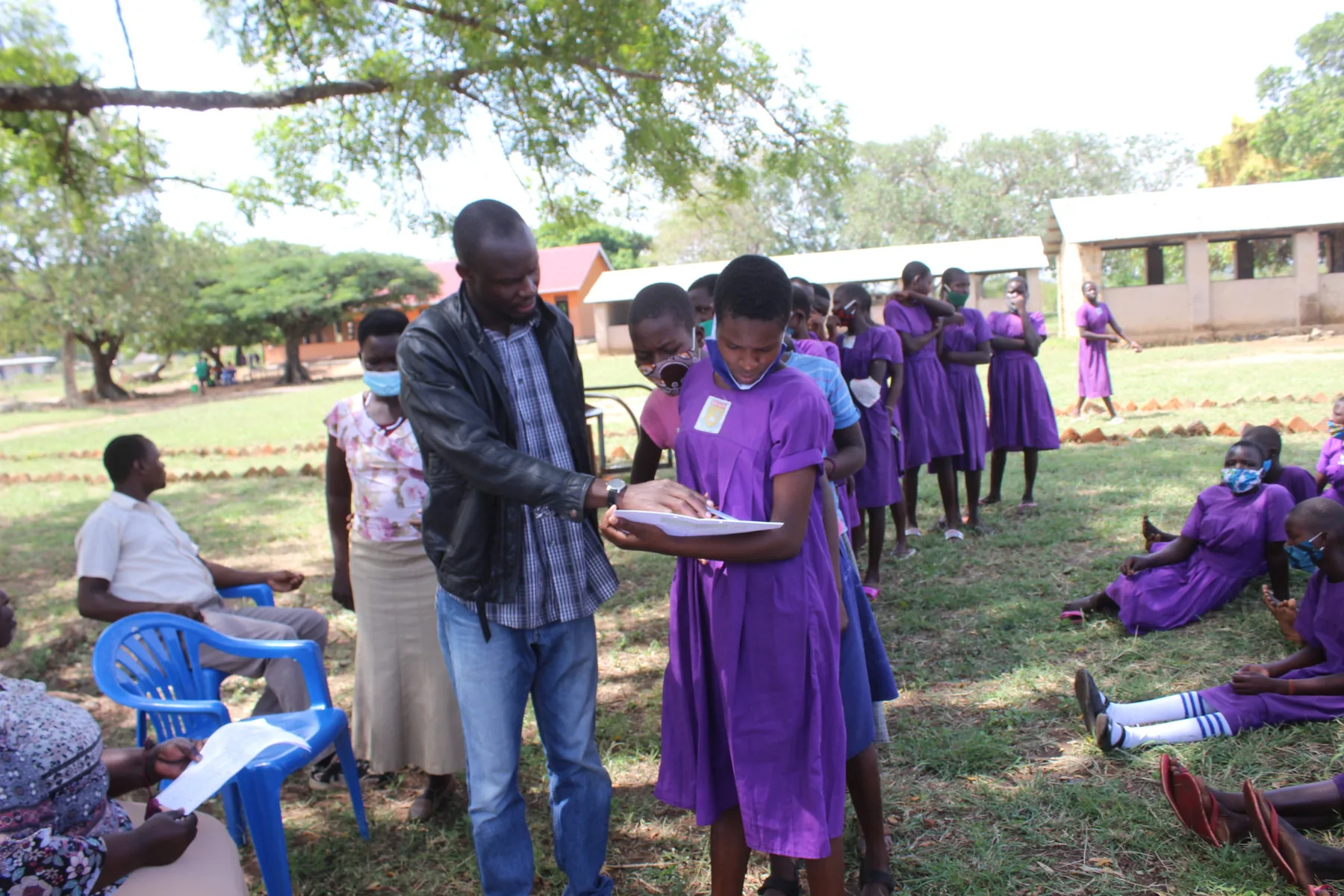 YWAFT team and school participants reviewing monitoring and feedback records