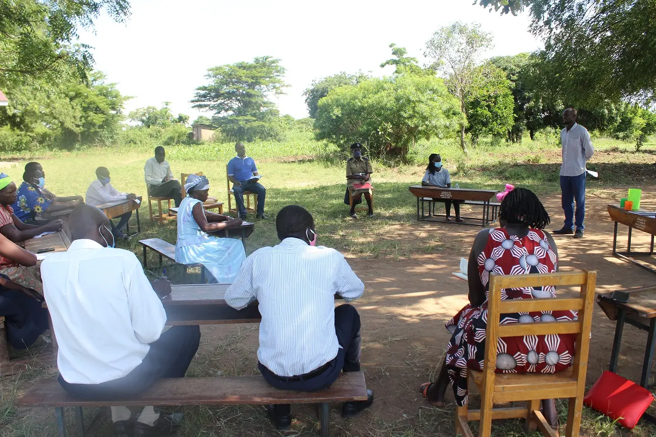 A YWAFT team member shares awareness materials with residents in a public market