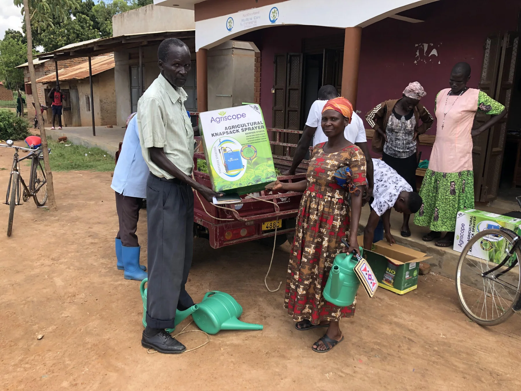 A farmer receives agricultural inputs during a YWAFT community distribution
