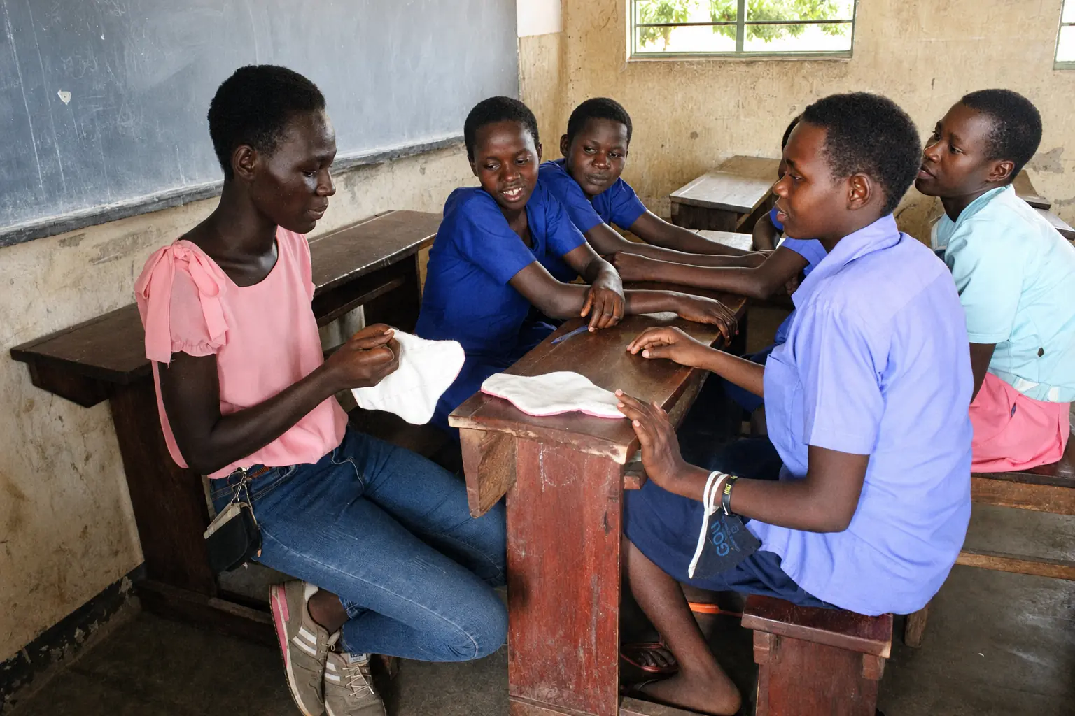 A facilitator demonstrates a reusable menstrual pad during a school session